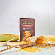 One box of Le Veneziane Gluten Free Pasta Ditalini pictured with corn in background and ditalini pasta on benchtop surrounding box.